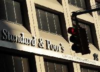 S&P revises UK credit rating outlook down to negative
