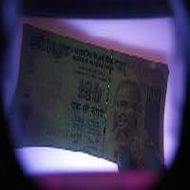 Rupee lower, bunched-up inflows seen